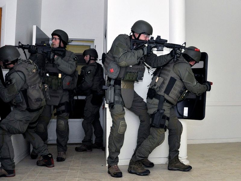Picture of a SWAT team getting ready to smash into a person's home as part of the War on Drugs.