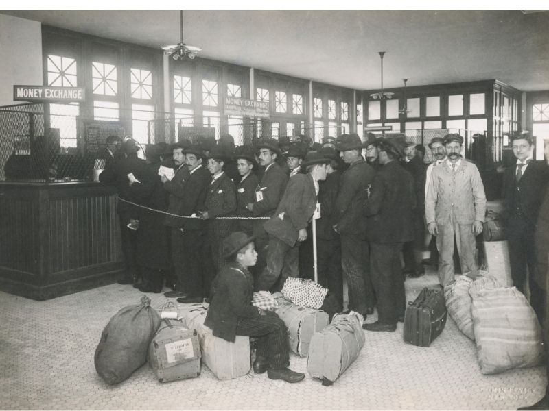 Black and white photo of immigrants lined up for processing at Ellis Island.