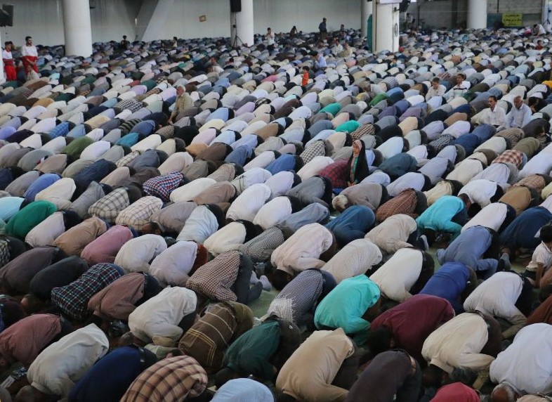 Photo of Muslims praying, indicating their belief in faith.