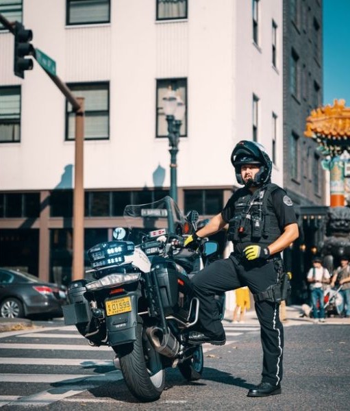 Policeman on motorcycle. Police is one of three functions of a proper government.
